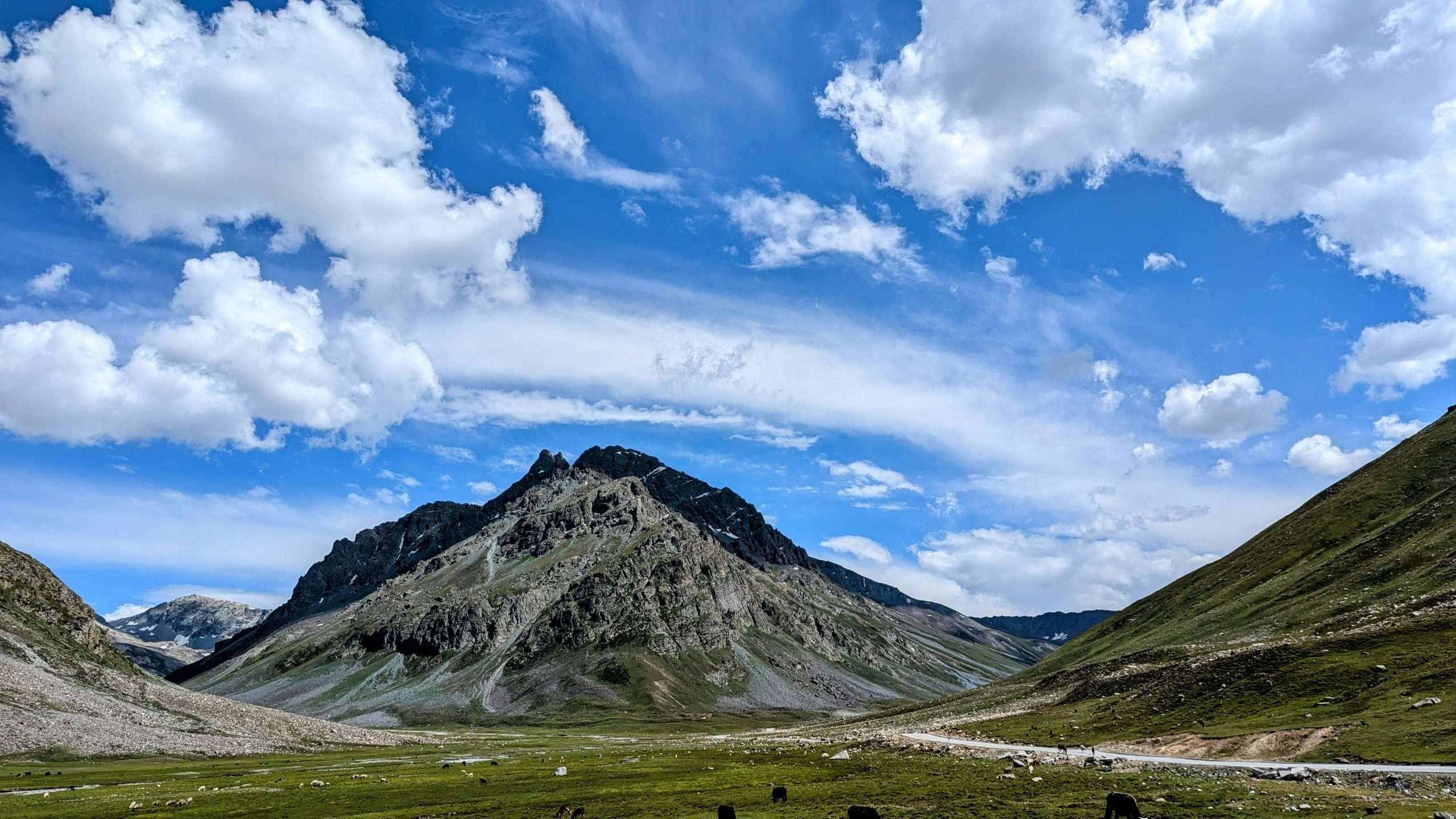 A stunning view of a mountain landscape under a bright blue sky in the Himalayas.